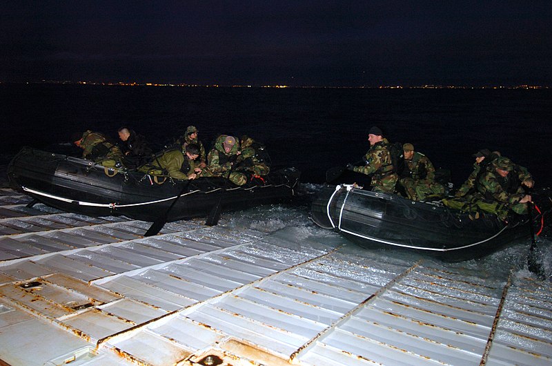 File:US Navy 060118-N-7027P-055 Using their oars, personnel assigned to U.S. Naval Special Clearance Team One (NSCT-1), pushes their combat rubber raiding crafts F-580 (CRRC) off the stern gate.jpg