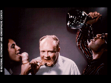 This image depicts humans licking, eating, and drinking as modes of consumption.