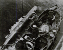 Whaleboat recovering an exercise torpedo. In the absence of torpedo retrievers a wide variety of small boats were pressed into recovery service. Whaleboat recovering an exercise torpedo.png