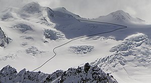 Marked ascent track of a previous ski tour to the Wildspitze (3.768 m) in Tyrolia in Austria. The route leads over the glacier Taschachferner, whereby the mountaineers made a detour around an area with open crevasses (middle). Wildspitze seen from Hinterer Brunnkogel, with marked ascent track of ski mountaineer.jpg