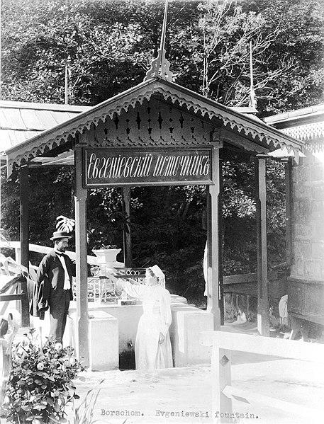 File:Woman handing man a glass of water at Evgeniewski (?) fountain, Borjomi, Georgia.jpg