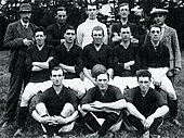 Players and staff pose for a photograph