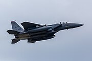 An F-15E Strike Eagle, tail number 91-0320, taking off from RAF Lakenheath in England. The aircraft is assigned to the 494th Fighter Squadron.