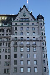 The northernmost portion of the eastern facade as seen from Fifth Avenue. The facade is white, and the top stories are within a triangular gable.