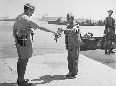 30 August 1945. Yokosuka Naval Base, Tokyo Bay. Commander Yuzo Tanno hands over the keys of the Yokosuka Naval Base to Captain H. J. Buchanan, Royal Australian Navy. Buchanan led the first British Commonwealth party to go ashore in Japan.