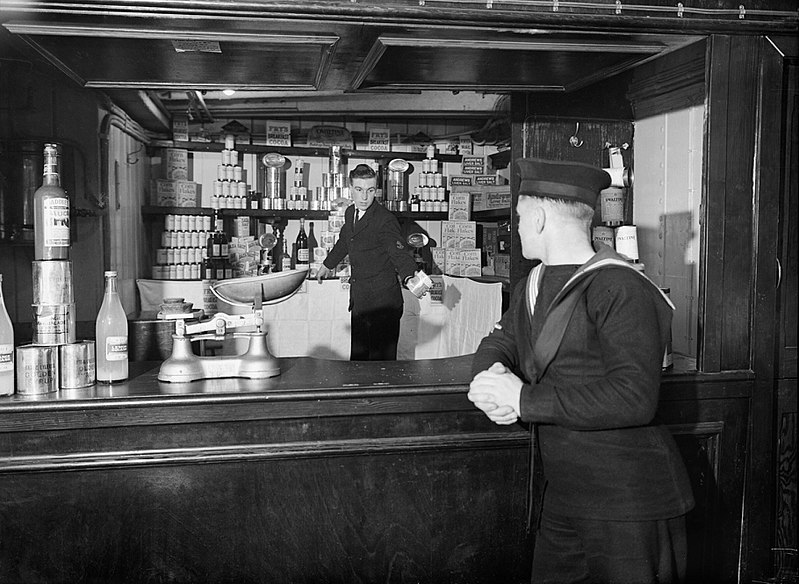 File:A sailor shopping in the NAAFI canteen on board the cross-channel steamer AUTOCARRIER, used as a recreation ship for the crews of Royal Navy auxiliary vessels, June 1943. A17414.jpg