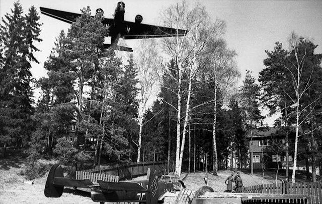 Lent's Bf 110C ran out of fuel during the Battle of Fornebu and was forced to land. A troop-carrying Ju 52 flies over Lent's Bf 110.