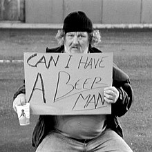 A man holding a sign using humor for begging CanIHaveABeerMan.jpg