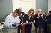 Sen. Sanders overseeing the signing of the agreement between the CIW and Burger King Ciw-bk.jpg