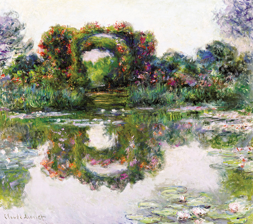 Flowering hedges form arches and reflect off the lilypad blooming water
