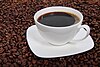 Coffee cup surrounded by coffee beans.jpg