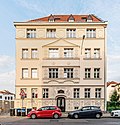 Apartment house in open development, as well as two former commercial buildings in the courtyard, courtyard paving and fencing in the courtyard