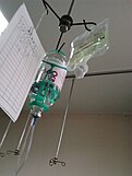 Modern intravenous therapy bags hanging from an IV pole