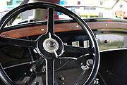 Steering column of a Model 613. One lever in the center controls the headlights, the other is the hand throttle