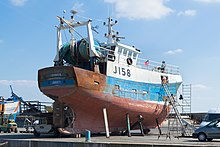 A 17-metre Jersey fishing trawler out of the water at Granville Granville Vieux Port 2014 03.jpg