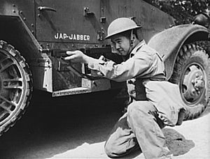 A Chinese American soldier posing alongside a half-track with an M1928A1 Thompson in hand, June 1942. Halftrack-fort-knox-4.jpg
