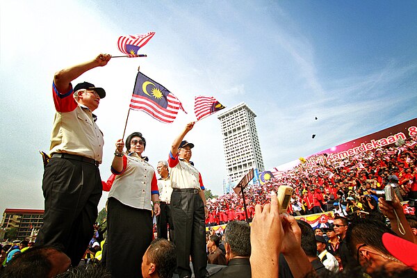 Najib and his wife Rosmah waving flags during the Malaysia Day celebration in Kuala Lumpur, 16 September 2011