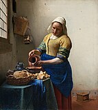 The Milkmaid by Johannes Vermeer (c. 1658). Vermeer was lavish in his choice of expensive pigments, including lead-tin yellow, natural ultramarine, and madder lake, as shown in the vibrant painting.[19]