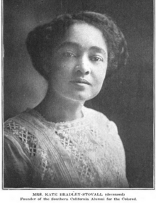 A young Black woman wearing a white dress or blouse