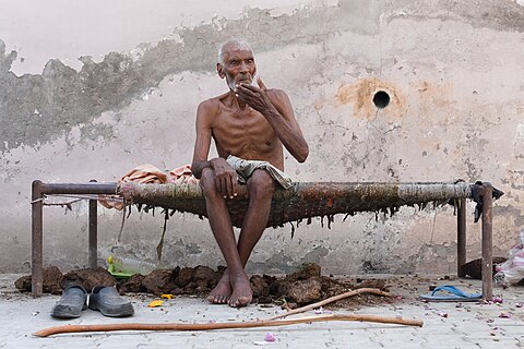 Khairdeen, alias Pritam, sitting on a cot outside his house in Jandali, district Ludhiana, Punjab, India