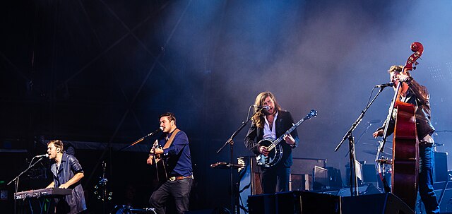 Mumford & Sons performing in 2015. From left to right: Ben Lovett, Marcus Mumford, Winston Marshall, and Ted Dwane.