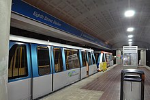 Rare double cars on the Brickell loop late at night. Metromover tandem cars at Eighth Street.jpg