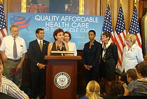 Secours speaks in 2009 at a Washington press conference about affordable healthcare; behind her were several congresspersons including Nancy Pelosi. Molly Secours (3748460236).jpg