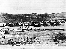 Pontoon causeway built by 21st Seabees to unload LSTs (Landing Ship, Tank)