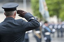 An RAF warrant officer saluting the colours. RAF Warrant Officer Saluting MOD 45157547.jpg