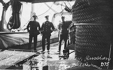 L to R, Rear Admiral Newton McCully, unknown Russian naval captain, Captain Zachariah Madison, commanding, aboard USS Des Moines, Russia, June 1919