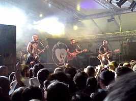 Rise Against performing in Segrate, Italy, in 2012. From left to right: Brandon Barnes, Zach Blair, Tim McIlrath and Joe Principe.