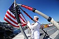 Sailors raise the national ensign. (14229194192).jpg