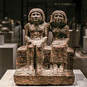 Seated portrait group of Dersenedj and his wife Nofretka; circa 2400 BC; rose granite; Egyptian Museum of Berlin