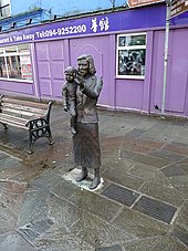 Statue in Swinford focusing on the impact of emigration from the area in the mid-20th century