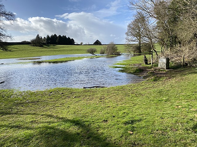 The meadow of Trewsbury Mead flooded with water, beneath the Thames Head marker stone, taken March 2020.