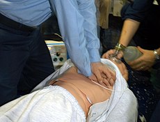 US Navy 040421-N-8090G-001 Hospital Corpsman 3rd Class Flowers administers chest compressions to a simulated cardiac arrest victim.jpg