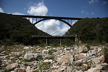 The N2 concrete arch bridge over the Van Stadens River in the background with the old R102 Van Stadens Pass bridge in the foreground. Photo was taken from the original drift over the river. VanStadensRiverBridges.JPG