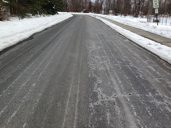 Salt brine sprayed and dried on a road surface for anti-icing before a snow storm