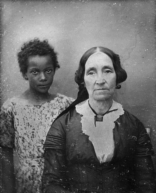 Portrait of an older woman in New Orleans with her enslaved servant girl in the mid-19th century