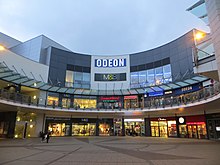 Eagles Meadow shopping centre in 2016 at night, with an Odeon Cinema , M&S and Tenpin.