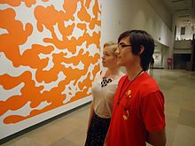 Young couple examining a painting