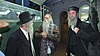 An Old bearded Jewish man wears a brown kippah
