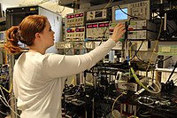 Adjusting a power meter at an optical communications system testbed.jpg