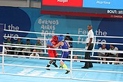 Deutsch: Boxen bei den Olympischen Jugendspielen 2018 Tag 12, 18. Oktober 2018 - Finale Fliegengewicht Mädchen – Martina La Piana (Italien, blau) schlägt Adijat Gbadamosi (Nigeria, rot) 5-0; Ringrichter ist James Beckles (Trinidad und Tobago). English: Boxing at the 2018 Summer Youth Olympics on 18 October 2018 – Girl's flyweight Gold Medal Bout - Martina La Piana (Italy, blue) beats Adijat Gbadamosi (Nigeria, red) 5-0; Referee is James Beckles (Trinidad and Tobago). Español: Boxeo en los Juegos Olímpicos Juveniles de Verano de 2018 en 18 de octubre de 2018 - Combate a medalla de oro de peso mosca para mujeres: Martina La Piana (Italia, azul) le gana a Adijat Gbadamosi (Nigeria, roja) 5-0; El árbitro es James Beckles (Trinidad y Tobago).