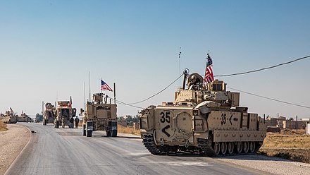A convoy of American MRAPs and Bradley Fighting Vehicles in eastern Syria during Operation Inherent Resolve