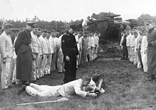 The Grosstraktor used for anti-tank training (tank on background) Bundesarchiv Bild 146-1979-107-13, Volkssturm, Ubung mit Panzerschreck.jpg