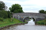 Shropshire Union Canal at Austin's Bridge; the old railway bridge is in the background