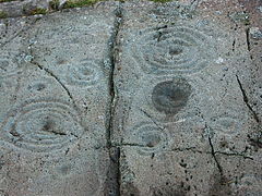 Tassen- und Ringmarkierungen auf beschriftetem Stein.jpg