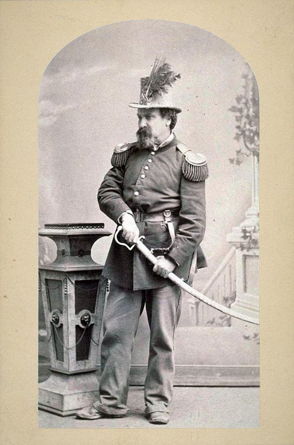 Emperor Norton in full dress uniform and military regalia, his hand on the hilt of a ceremonial sabre, c. 1875