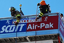 Hose Hoist-Competitor raising a 42 lb. donut roll up the 5 story FCC Tower FFCB Hose Hoist.jpg